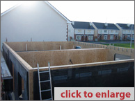 Erect ground floor walls, beams, and joisting.